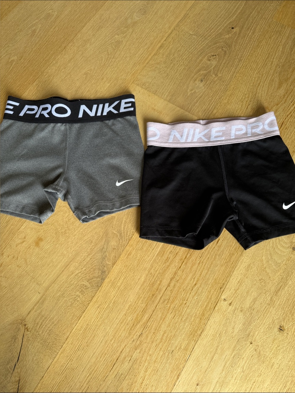 Gray and black Nike pros with pink and black waist band